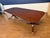 This is a classic traditional banded mahogany dining table by Leighton Hall. It features an understated field of cathedral...