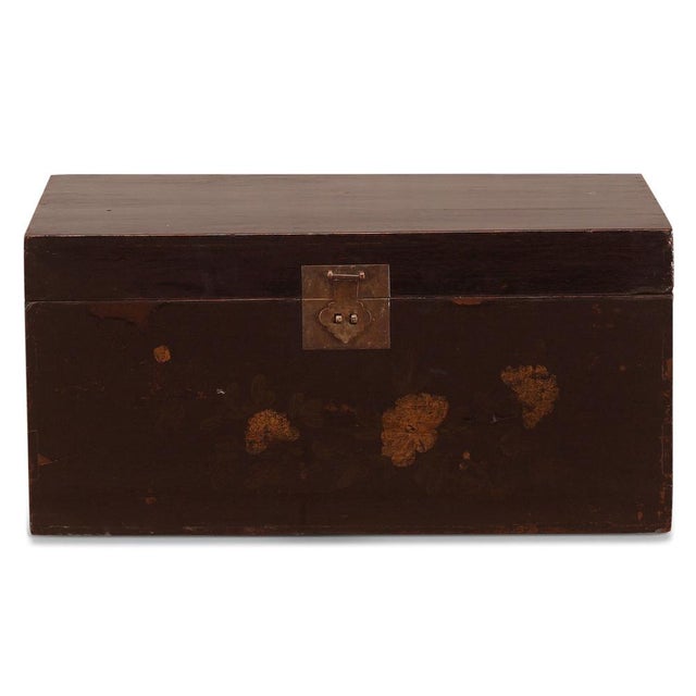This lovely old trunk is in its original black lacquer, with simple floral paintings on the front of peony flowers and...