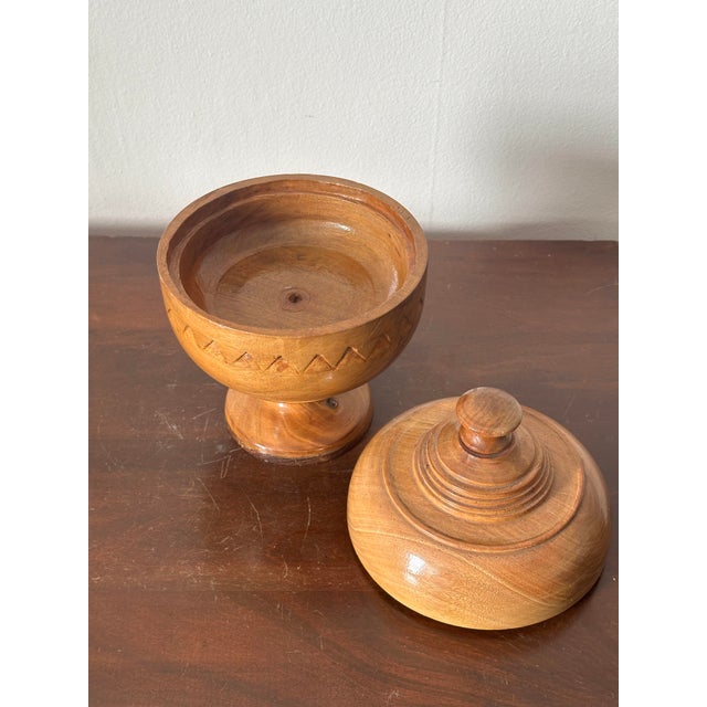 Difficult to date this handcrafted wooden treenware standing at 9” tall and 6” diameter typically used as a spice, sugar,...