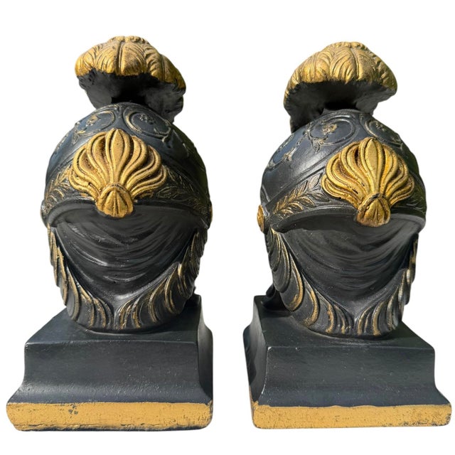 Substantial pair of neoclassical bookends modeled after ancient Greek Corinthian helmets. Finished in matte black with...