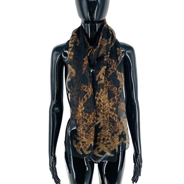 Chanel Black Printed 100% Silk Scarf. Sheer black silk chiffon printed with gold-tan chain links and quilted interlocking...