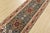 A traditional tribal Heriz runner hand-knotted with an all-wool pile on a cotton foundation. This oriental rug features...