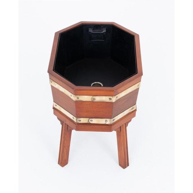 A handsome Regency-style mahogany wine cooler of octagonal form, showcasing elegant design and fine craftsmanship. The...