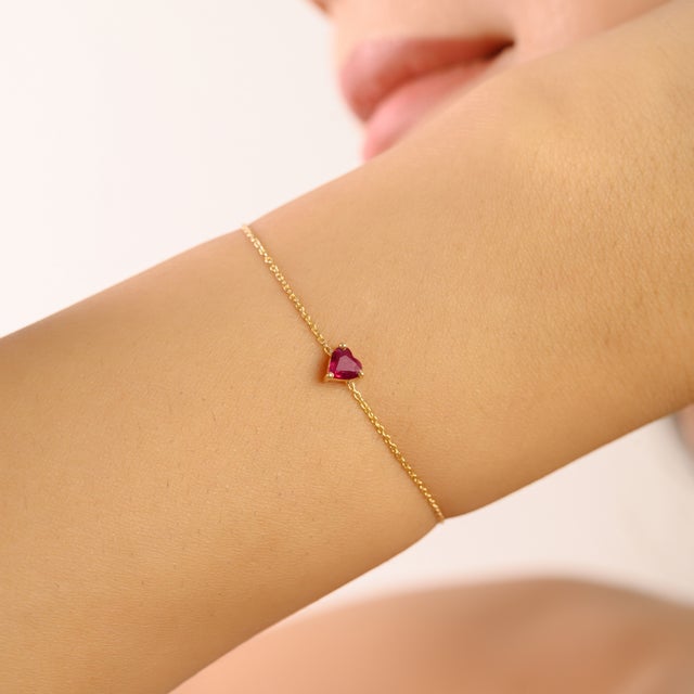 This elegant bracelet showcases a single heart-shaped natural ruby weighing 0.41 carats, measuring approximately 4.1 x 4.4...