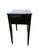 A dramatic 1970s Hollywood Regency side table finished in deep ebony lacquer and framed with gilded faux bamboo trim. The...