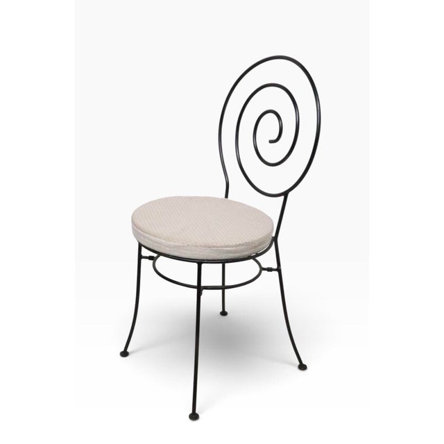 Stylish vintage wrought iron cafe bistro style garden, patio, poolside dining set, having two chairs, and a glass top...
