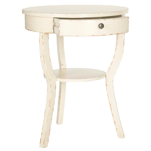 The classically styled end table assumes a fashion edge with chic colors and finishes. it's round top and shelf supported...