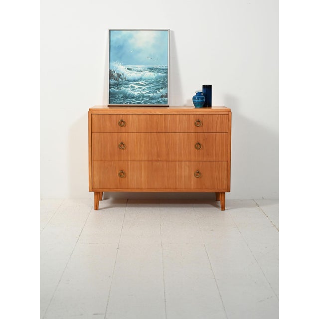 Art Deco chest of drawers in elm with three drawers and double brass ring handles. Scandinavian Art Deco chest of drawers...