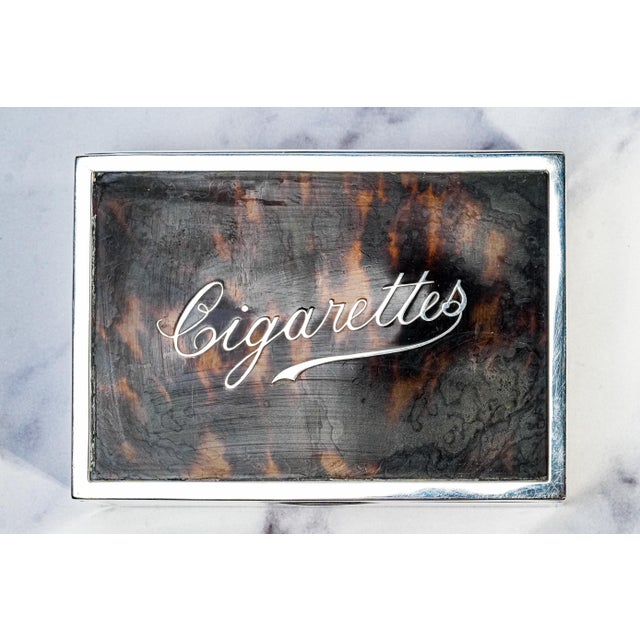 Immerse yourself in the elegance of Edwardian-era craftsmanship with this sterling silver cigarette box, an extraordinary...