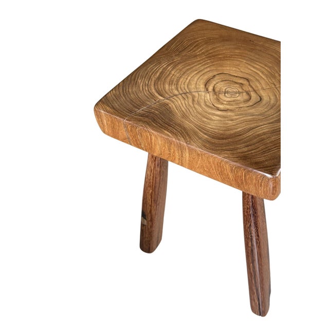 This sculptural solid teak wood stool is a striking expression of natural material and refined craftsmanship. Carved from...