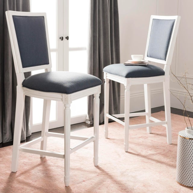 Entertain in style with this angle barstool. Designed to bring French charm to the table, it's chic navy upholstery is...