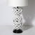 This materially exquisite Mid-Century Modernist Open Form White Ceramic Table Lamp W/Woven Sculptural Motif Manner of Tony...