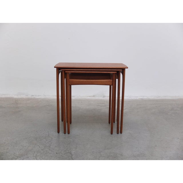 Beautiful set of nesting tables designed by Svend Åge Madsen around 1960. This set features three tables that slide into...