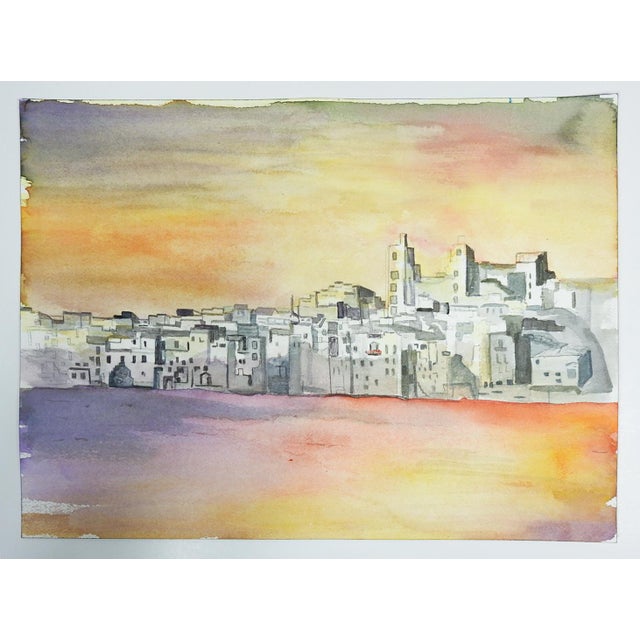 Late 20th century watercolor on paper surreal painting of coastal town at sunset. Unsigned. Unframed.