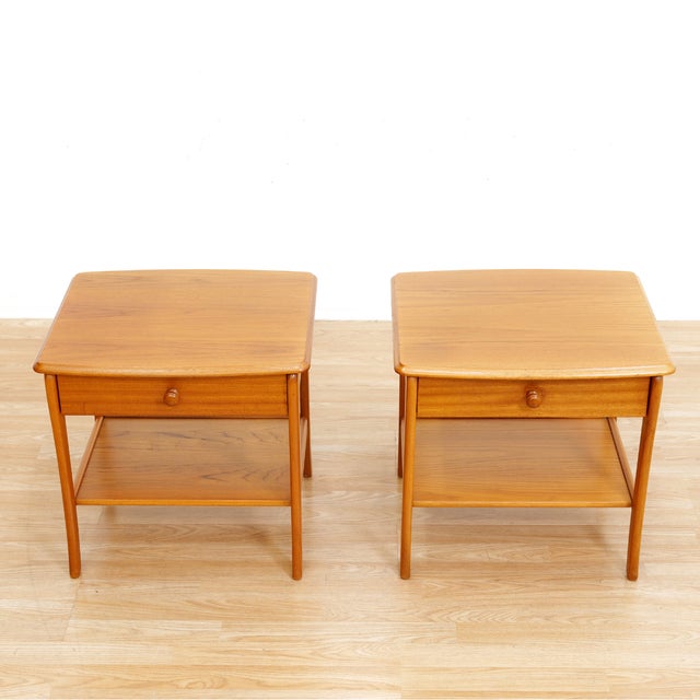 This pair of mid-century nightstands were produced by Nathan Furniture during the 1970s. A delicate pair of teak bedside...