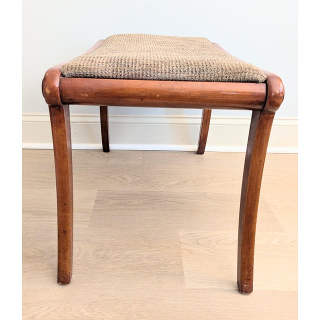 This is a beautiful saber-legged bench/ottoman estimated to be a mid-century piece. Simply gorgeous styling with graceful...