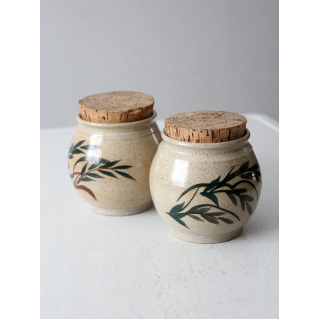 This is a pair of vintage Lakeside Pottery ceramic jars with cork lids. Signed by the artist, the handmade jars have a...