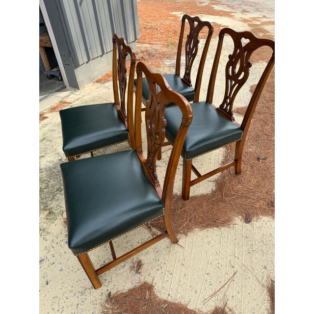 A beautiful set of 4 Chippendale dining chairs. Lovely intricate carvings on the seat backs. Square carved legs with...