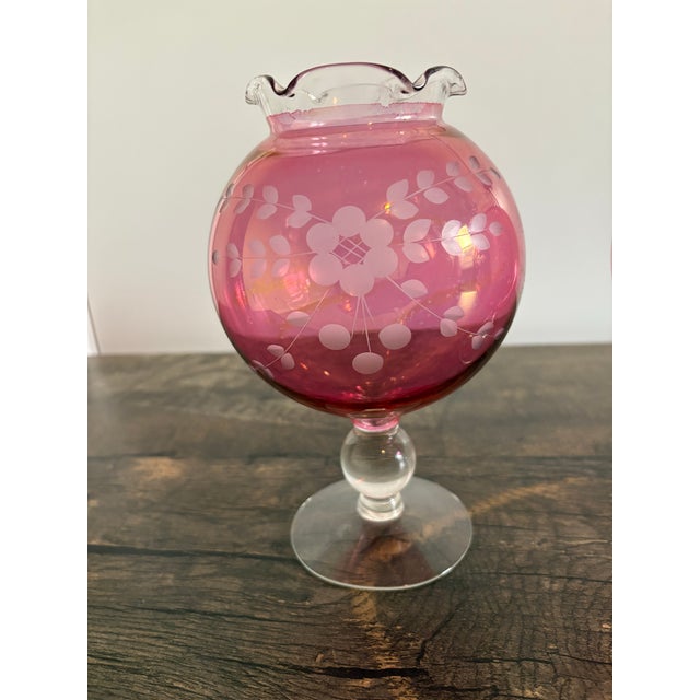 It’s a Vintage Cranberry Etched Vase from the 1950’s. The color is just so vibrant and beautiful. It will bring cheer to...