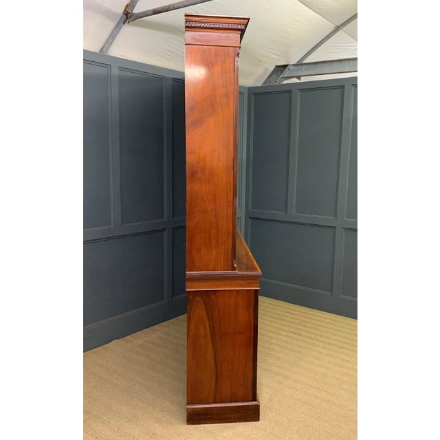 A superb quality inlaid mahogany bookcase by Edwards and Roberts of London. Of fine construction in a dense grade of solid...