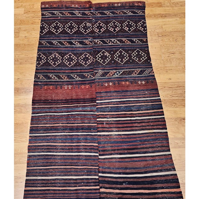 This early 20th century Turkish kilim is a piece of rare cultural depth, its design drawing on the visual vocabularies of...