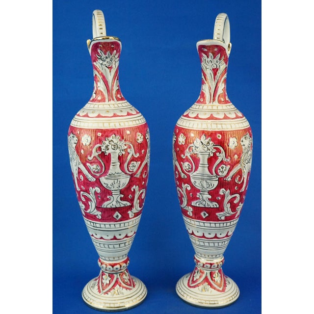 Item : A beautiful pair of glazed and vitrified ceramic amphorae, entirely hand-decorated with lightly raised decorations...