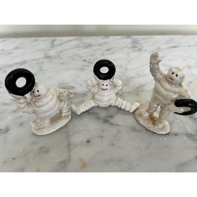 Set of 3 vintage cast iron ‘Michelin Man’ models The Michelin brothers commissioned the French cartoonist O’Galop to...