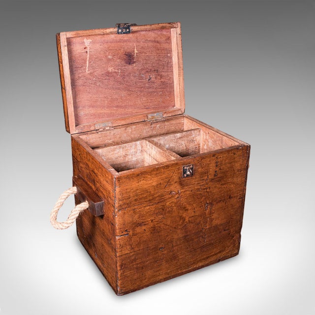 This is an antique maritime decanter box. An English, solid walnut rum or whiskey storage case, dating to the late...