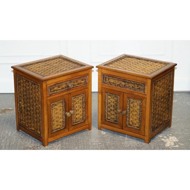 Antiques of London A charming vintage pair of wicker or rattan nightstands, each designed with a practical drawer above a...
