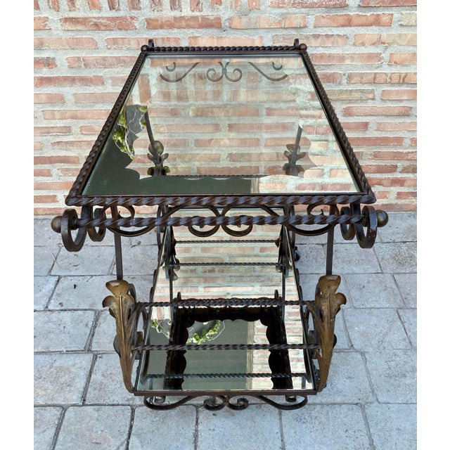 This charming and quirky 19th century painted wrought cast iron table is mounted on casters and equipped with two trays, a...