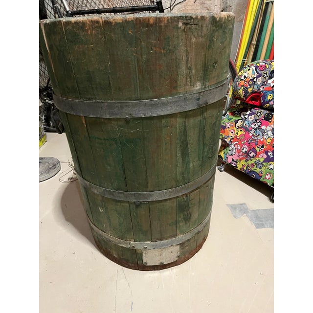 Tall green stained wooden bucket with ornate lifting handles and metal straps
