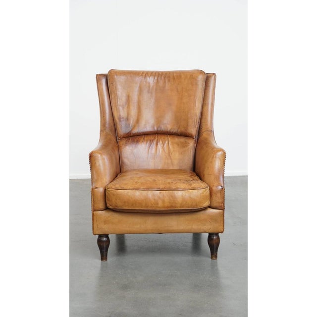 Offered is this comfortable and stylish vintage armchair/ armchair made of sheep leather with a unique character. This...