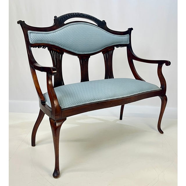 Antique mahogany lyre-back settee that showcases the transitions between the Federal, Empire, and Classical Revival...