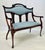 Antique mahogany lyre-back settee that showcases the transitions between the Federal, Empire, and Classical Revival...