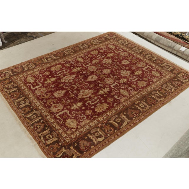 Hand-knotted in all wool, an Agra inspired floral rug relishing gorgeous striations on a 9x12 frame. The floral palmette...