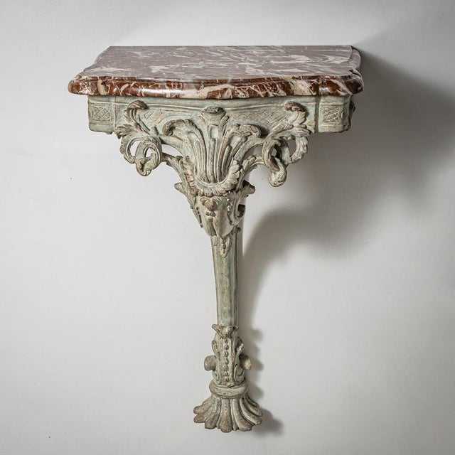 Baroque wall console made of oak with a light gray painted finish and a red-and-white veined marble top. Richly carved...