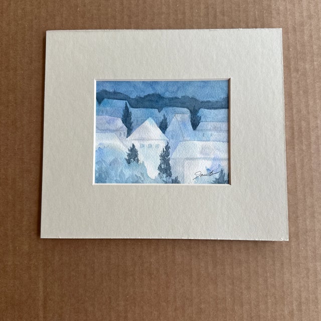 This piece features a serene landscape of houses with a cool, muted color palette dominated by shades of blue and gray....