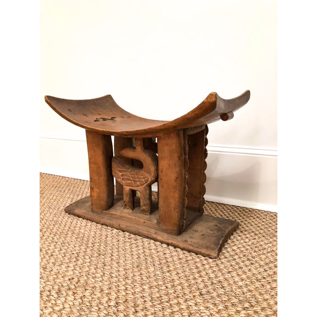 This wood carved Ashanti stool features a scoop seat and decorative carving detail on the body of the stool. Great way to...