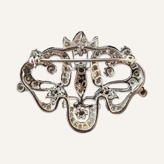 Lady’s Edwardian style platinum and diamond convertible brooch/pendant. 46 single cut diamonds with a total weight of...