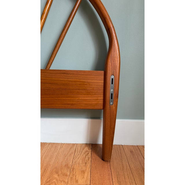 Queen sized. Featuring sleek arched headboard constructed with solid teak spindles and legs, a low profile footboard and...