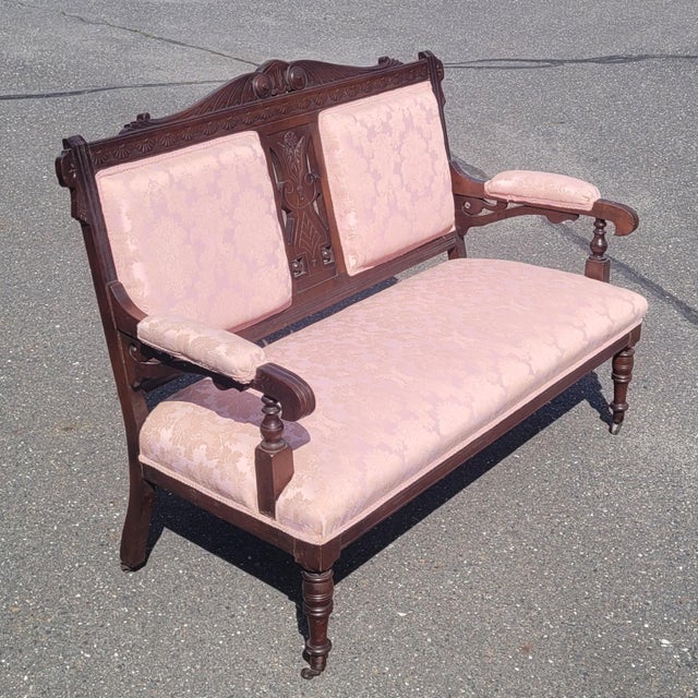 Super fine and stylish Victorian era Edwardian style 1880s settee. Featuring pink floral Edwardian fabric carved frame...