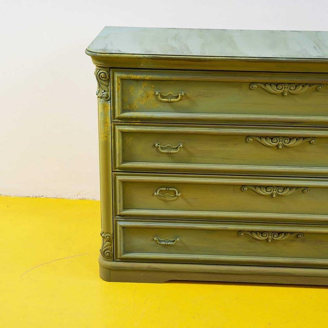 Discover the timeless elegance of this vintage dresser, featuring a unique green finish and embossed details that enhance...
