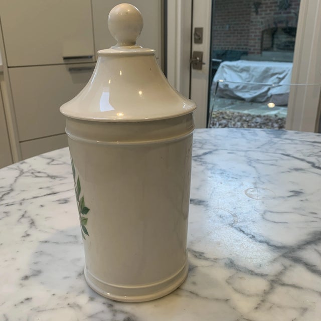 Late 19th century French Porcelain apothecary Jar with laurel wreath framing identity of contents. Manufactured by E....
