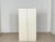 Spacious and functional vintage shoe cabinet from the 1960s. Behind the minimalist white double doors lies a well-designed...