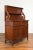 An antique Indonesian dining display cabinet from the early 20th century, with two drawers and two doors with carved...
