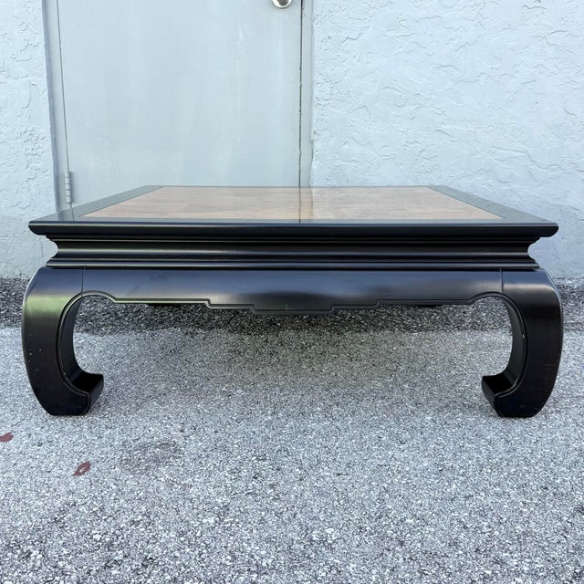 This Ming style coffee table by Ethan Allen pairs classic Asian-inspired design with striking contrast. The square top...