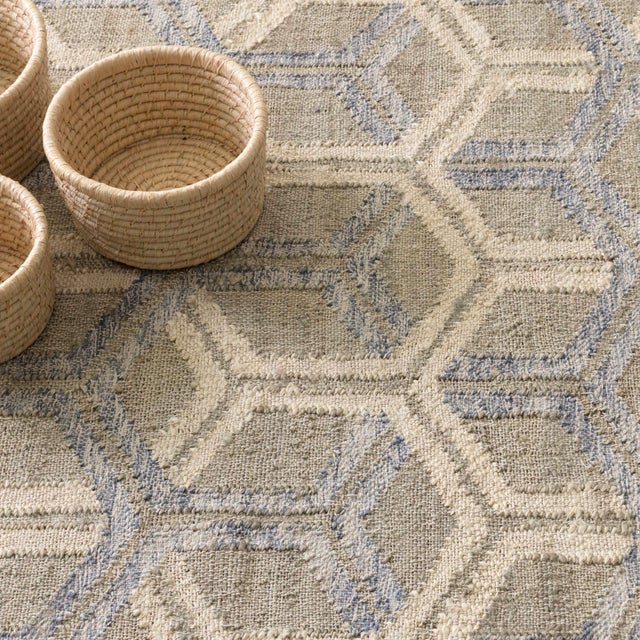 For a modern angle, stylized motifs of interlocking honeycombs in blue and natural hues float on a natural jute ground....
