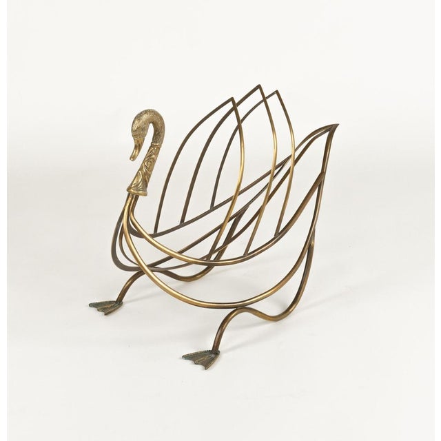 Midcentury beautiful swan figure magazine rack in brass attributed to Maison Jansen. Made in France in the 1970s. This...