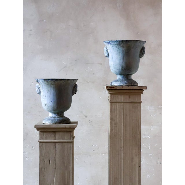 Antique French cast iron garden urns by Paris en Cie, designed in a classic urn shape. These cast iron urns are...