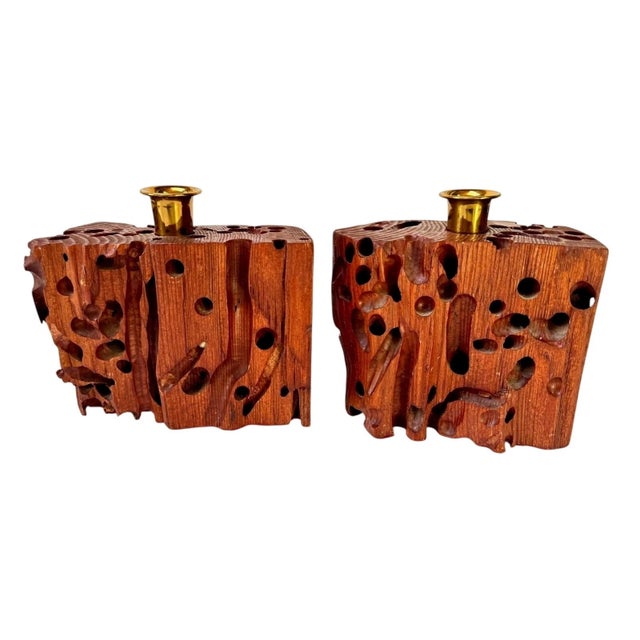 Sculptural pair of mid-century candleholders made from solid hardwood featuring dramatic natural insect-eaten voids. The...